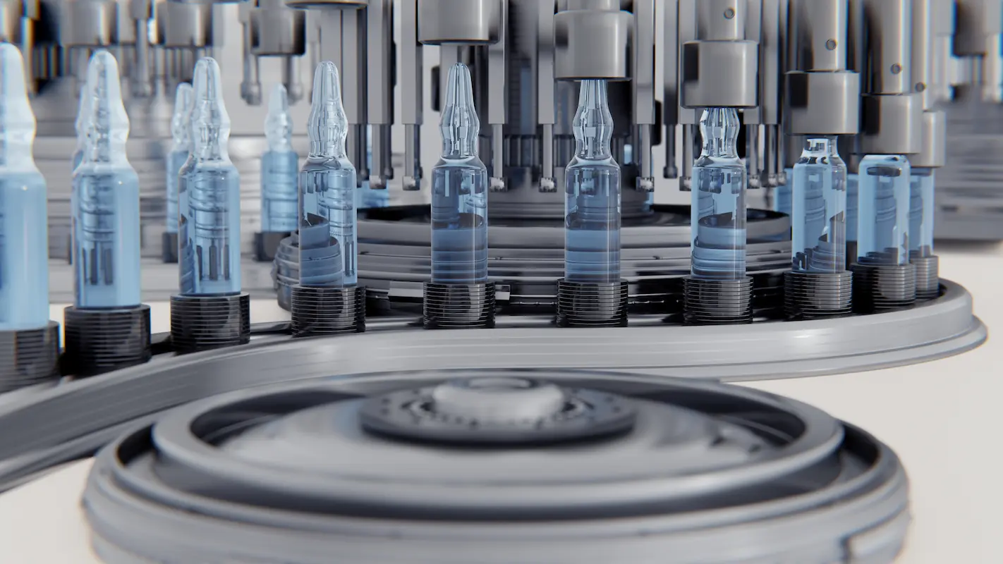 A close-up view of an automated assembly line with transparent blue vials being filled by a machine.